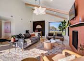 Thumbnail 22 of 42 - a living room with a couch and a fireplace