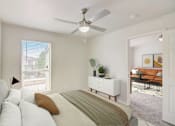 Thumbnail 9 of 33 - a bedroom with a bed and a ceiling fan
