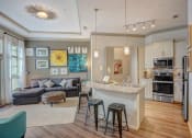 Thumbnail 19 of 52 - an open living room and kitchen with a bar and a counter top
