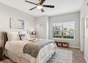 Thumbnail 8 of 70 - A bedroom with a large bed and a window overlooking a parking lot.