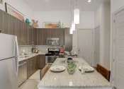 Thumbnail 8 of 37 - a kitchen with stainless steel appliances and a granite counter top