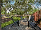 Thumbnail 11 of 17 - a patio with chairs and a fire pit
