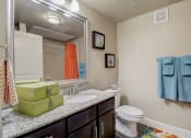 Thumbnail 12 of 50 - a bathroom with a sink and toilet and a mirror