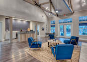 Thumbnail 14 of 17 - a living room with blue chairs and a table