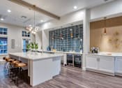 Thumbnail 13 of 17 - a kitchen with a large counter top and some stools