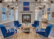 Thumbnail 3 of 17 - a living room with blue chairs and a fireplace
