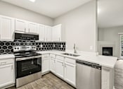 Thumbnail 11 of 48 - A kitchen with white cabinets and a black and white tiled backsplash.