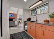 Thumbnail 27 of 42 - a kitchen with orange cabinets and a sink and a window