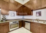 Thumbnail 22 of 42 - a kitchen with wooden cabinets and stainless steel appliances