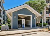 Thumbnail 43 of 55 - A modern two-story building with a garage door open.