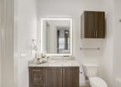 Thumbnail 16 of 37 - a bathroom with a toilet sink and a mirror