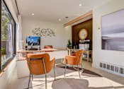 Thumbnail 25 of 42 - a dining room with a table and chairs and a large window