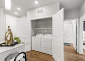 Thumbnail 10 of 29 - A modern laundry room with a washer and dryer built into the cabinetry.