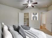 Thumbnail 8 of 36 - an empty bedroom with a bed and a ceiling fan