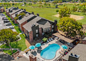 Thumbnail 15 of 18 - an aerial view of a house with a swimming pool and patio umbrellas