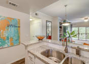 Thumbnail 6 of 44 - an open kitchen with a stainless steel sink and counter top