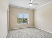 Thumbnail 7 of 32 - A room with a ceiling fan and a window with blinds.