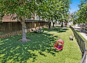 Thumbnail 37 of 55 - A backyard with a red slide and a green lawn.
