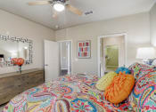 Thumbnail 9 of 50 - a bedroom with a bed and a ceiling fan