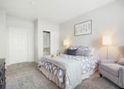 Thumbnail 8 of 48 - a bedroom with a bed and a chair