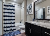 Thumbnail 4 of 28 - a bathroom with a black and white shower curtain