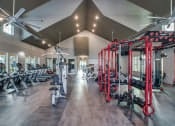 Thumbnail 13 of 28 - a spacious fitness center with cardio machines and weights