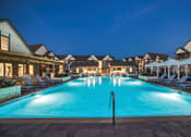 Thumbnail 22 of 28 - a resort style swimming pool with lounge chairs and umbrellas