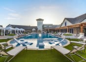 Thumbnail 17 of 28 - a large swimming pool with lounge chairs and umbrellas