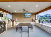 Thumbnail 16 of 28 - the gathering place at gardner village outdoor patio with table and chairs and barbecue grill