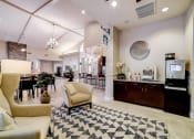 Thumbnail 20 of 42 - a lobby with couches and chairs and a coffee bar