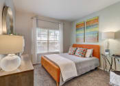 Thumbnail 12 of 44 - a bedroom with a bed and a desk and a window