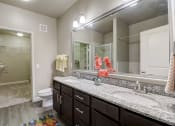Thumbnail 10 of 50 - a bathroom with two sinks and a mirror and a toilet