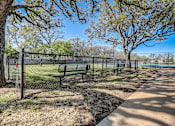 Thumbnail 32 of 42 - two park benches in front of a fence near a tennis court