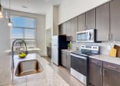 Thumbnail 1 of 44 - an open kitchen with stainless steel appliances and granite counter tops