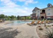Thumbnail 27 of 48 - the preserve at ballantyne commons community pool and hot tub with apartment buildings in the background
