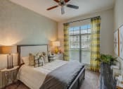 Thumbnail 24 of 52 - a bedroom with a large bed and a ceiling fan