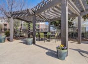 Thumbnail 23 of 42 - a patio with a pergola and tables and chairs