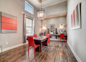 Thumbnail 28 of 42 - a dining area with a table and chairs and a chandelier