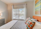 Thumbnail 13 of 44 - a bedroom with a large bed and a window
