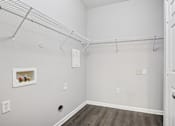 Thumbnail 18 of 70 - A white room with a door and a shelf with jars on it.