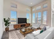 Thumbnail 4 of 44 - a living room with a white couch and a television