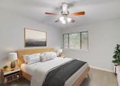 Thumbnail 5 of 23 - a bedroom with a large bed and a ceiling fan