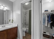 Thumbnail 15 of 37 - a bathroom with a shower and a sink and a mirror