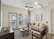 Thumbnail 4 of 30 - A living room with a black coffee table and a brown chair.