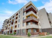 Thumbnail 48 of 50 - a large apartment building with balconies and a blue sky