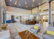 Thumbnail 23 of 44 - a lobby with couches and a table and a reception desk