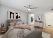 Thumbnail 6 of 19 - a bedroom with a large bed and a ceiling fan