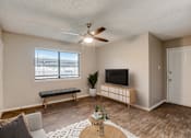 Thumbnail 9 of 42 - a living room with a ceiling fan and a window