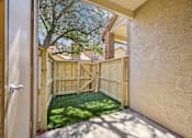 Thumbnail 17 of 45 - A wooden gate opens to a backyard with a green lawn.