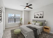 Thumbnail 28 of 70 - A bedroom with a bed, a chair, and a ceiling fan.